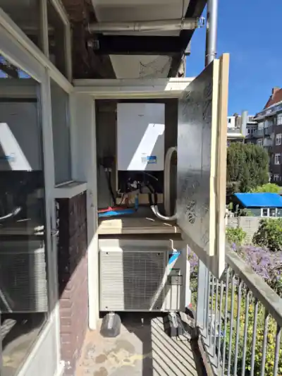 Daikin Altherma 3 split warmtepomp in een kast ingebouwd op een balkon van een Amsterdams appartement. De warmtepomp bestaat uit binnen- en buitenunit.